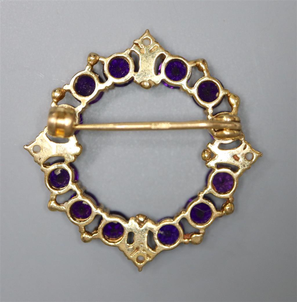 A modern 9ct gold, amethyst and seed pearl set openwork brooch, 25mm, gross 4.4 grams.